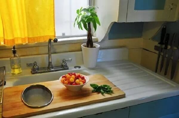 Keep an over-the-sink cutting board handy to temporarily expand your counter space. #Kitchen #KitchenOrganization #KitchenDecor #KitchenStorage