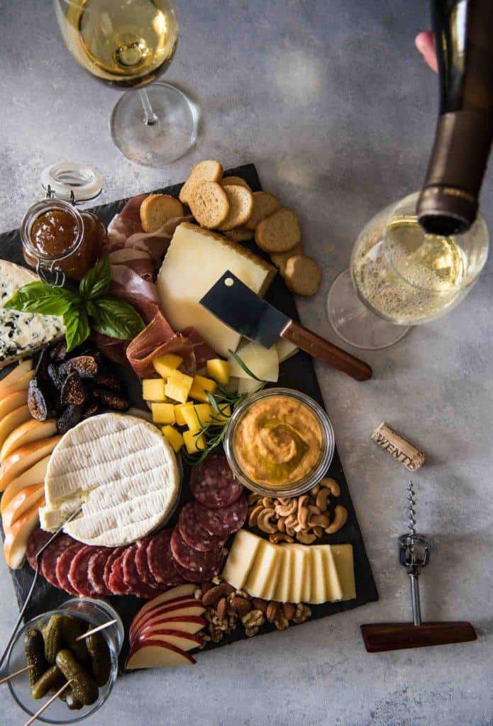 Looking for some amazing charcuterie board ideas to wow your guests on your next holiday parties? Learn how to make a charcuterie board plus get a list of the best cheese boards perfect for a crowd! #appetizers | simple charcuterie board | easy charcuterie board | cheap charcuterie board | food platter | entertaining | fall charcuterie board | thanksgiving charcuterie board | Image via The Crumby Kitchen