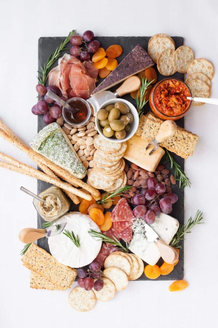 Looking for some amazing charcuterie board ideas to wow your guests on your next holiday parties? Learn how to make a charcuterie board plus get a list of the best cheese boards perfect for a crowd! #appetizers | simple charcuterie board | easy charcuterie board | cheap charcuterie board | food platter | entertaining | fall charcuterie board | thanksgiving charcuterie board | Image via Wholefully