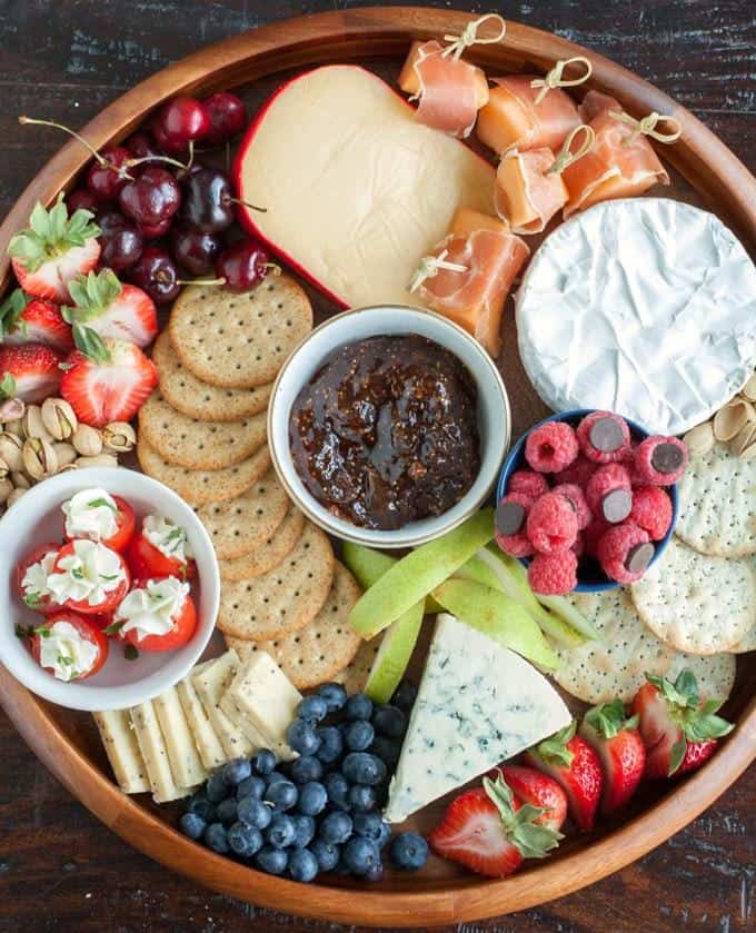 Looking for some amazing charcuterie board ideas to wow your guests on your next holiday parties? Learn how to make a charcuterie board plus get a list of the best cheese boards perfect for a crowd! #appetizers | simple charcuterie board | easy charcuterie board | cheap charcuterie board | food platter | entertaining | fall charcuterie board | thanksgiving charcuterie board | Image via Food Lovin Family
