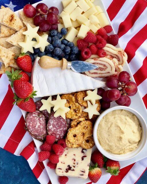 Patriotic Cheese Board - The Preppy Hostess via The Preppy Hostess. These 22 festive and fun 4th of July party food ideas are guaranteed to impress everyone! They are perfect for a large crowd and even kids and adults will love. Find appetizers, BBQ, desserts, and other red, white and blue recipe ideas here!
