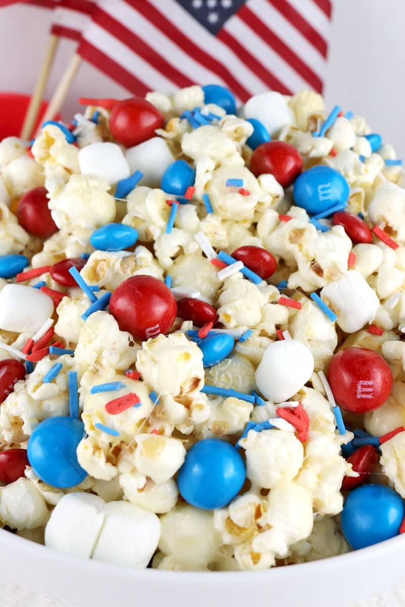 Patriotic Popcorn via Two Sisters. These 22 festive and fun 4th of July party food ideas are guaranteed to impress everyone! They are perfect for a large crowd and even kids and adults will love. Find appetizers, BBQ, desserts, and other red, white and blue recipe ideas here!