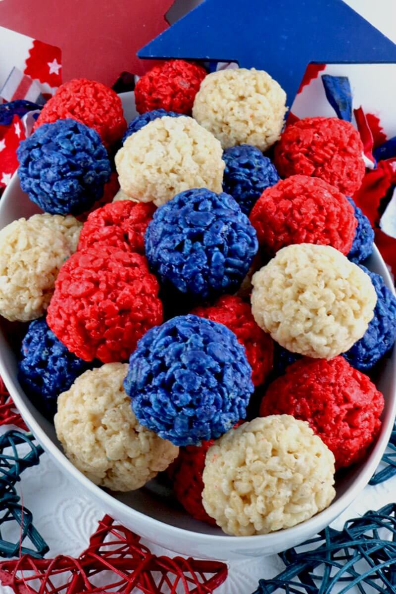 Red White and Blue Rice Krispie Bites are yummy, bite-sized balls of crunchy, marshmallow-y Patriotic delight.