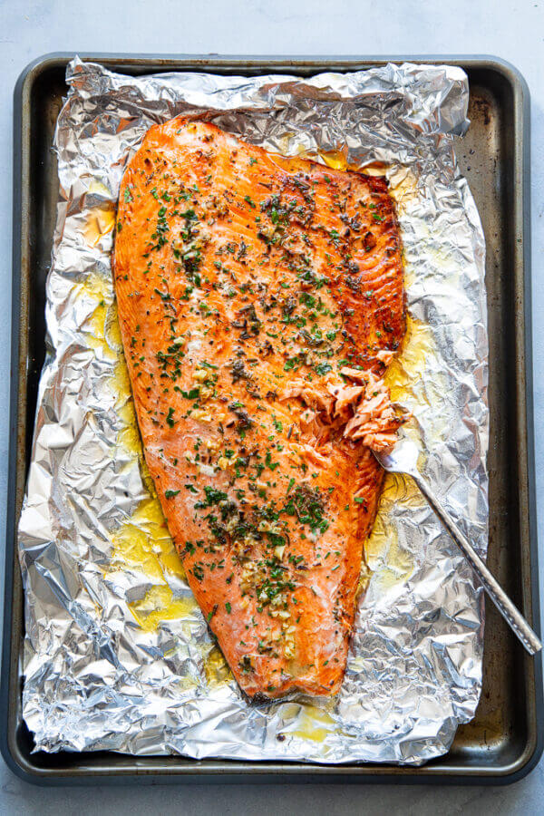 Baked Salmon in Foil with Garlic, Rosemary, and Thyme via Paleo Running Momma. Healthy, easy, and incredibly delicious salmon recipes you'll want to eat over and over again for breakfast,  lunch, or dinner! Find baked salmon, grilled salmon, smoked, pan-seared, and more!