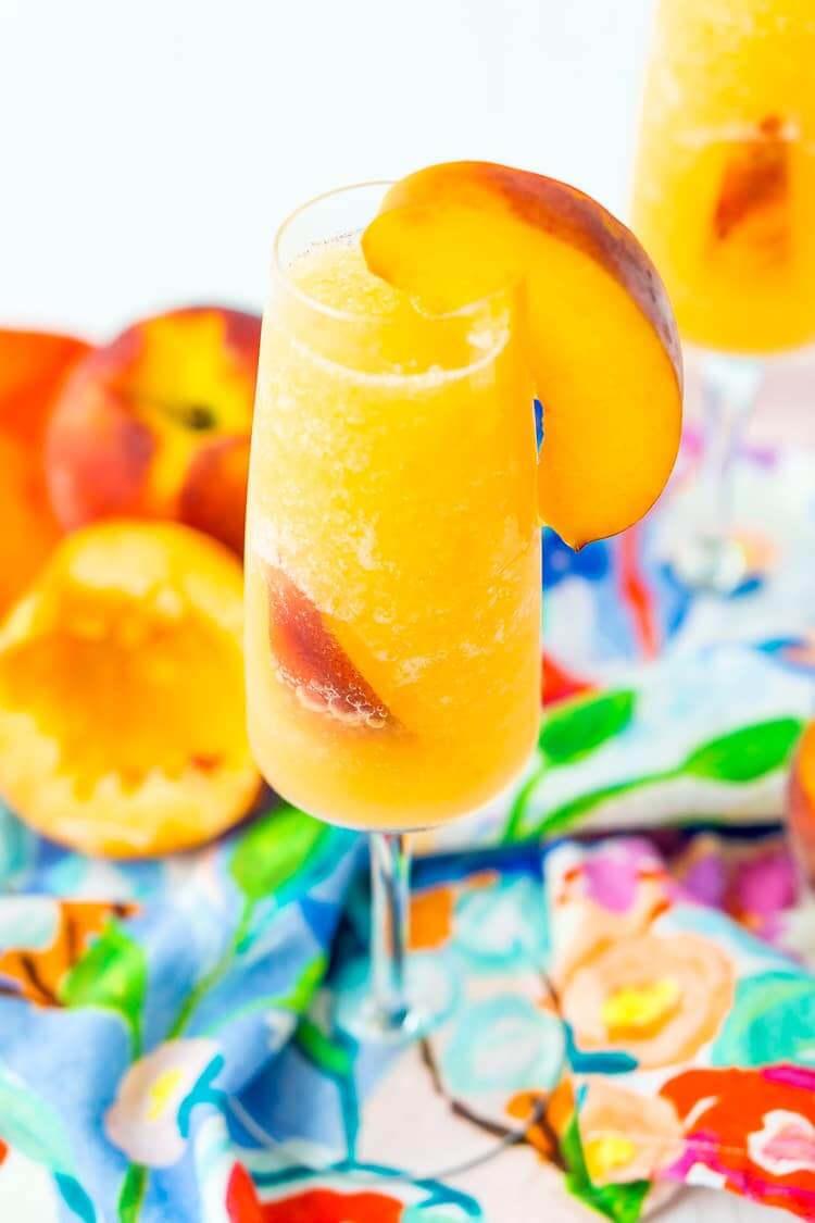 Frozen Peach Bellini Cocktail Recipe get the full recipe on SUGAR & SOUL. These easy cocktail recipes are a refreshing treat to beat the heat this summer! Find mojito recipes, lemonade cocktails, Hawaiian mimosas, tequilas, and more!