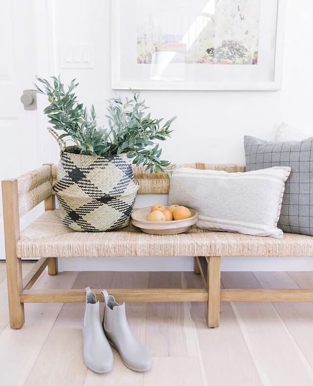 Pretty fall decor for the living room with cute pillows and a basket.