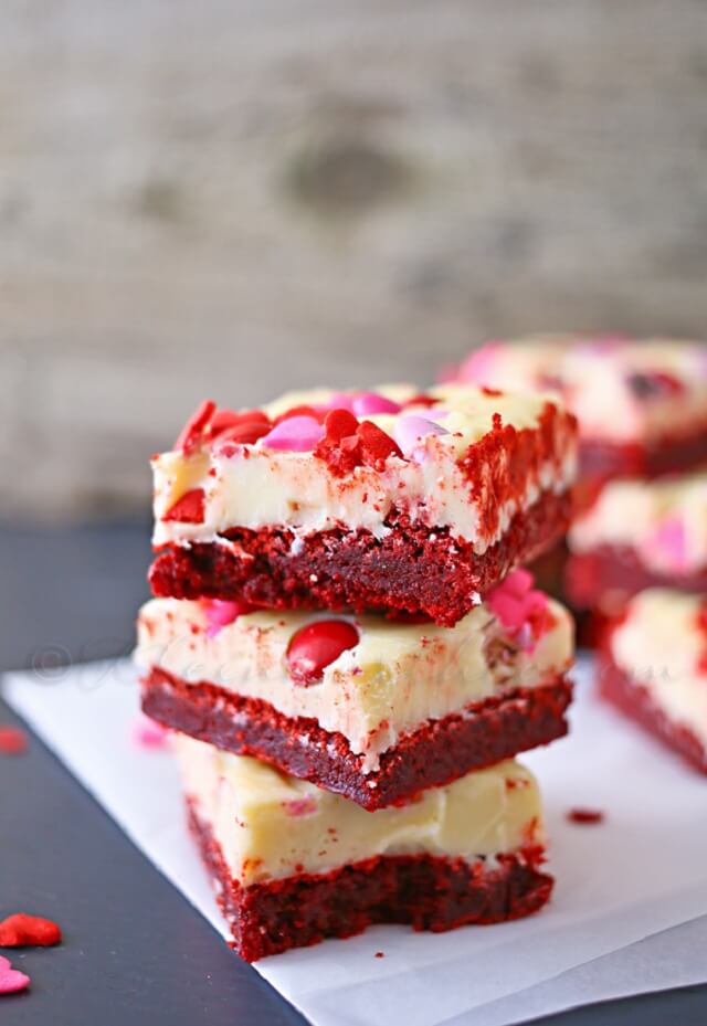 a rich and chewy texture and are topped with white chocolate icing and Valentine sprinkles