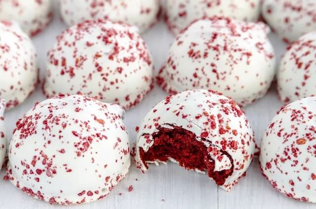 The cake balls are dipped in candy coating to create a candy version of a moist, sweet, and tangy cake bite.