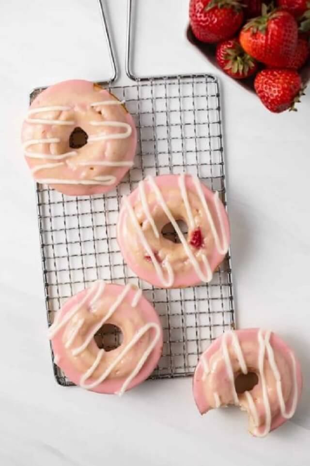 this recipe has cream cheese icing drizzled on top, a strawberry glaze on top, and are flecked with fresh strawberry chunks