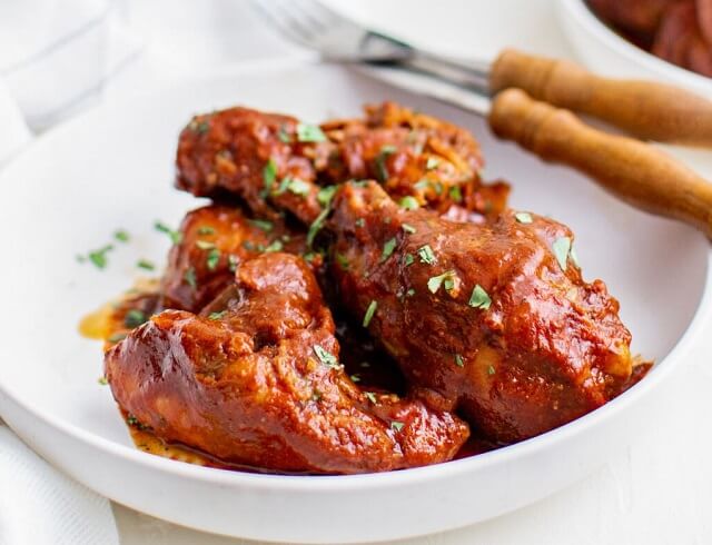 This recipe is made with dried chilies and ingredients to make a smokey homemade adobo sauce in which you braise your chicken until it falls off the bone!