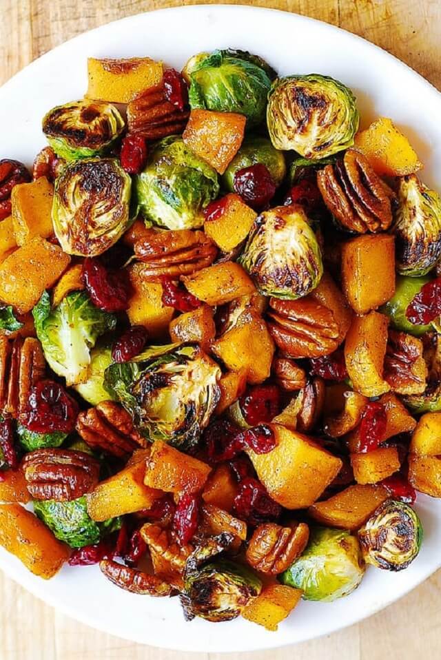One of the best holiday side dishes you'll ever have is roasted butternut squash and Brussels sprouts with pecans and cranberries.