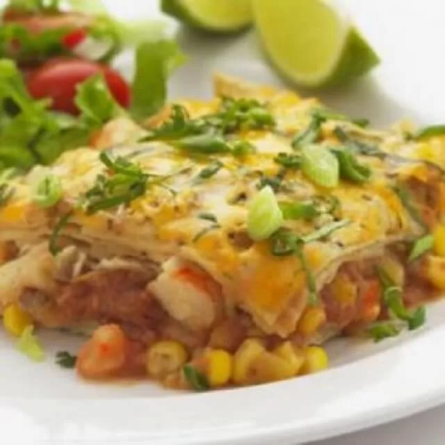 With classic enchilada flavors, low-calorie shrimp, and fresh vegetables, this casserole is not only tasty but also quick and easy to make for a weeknight dinner.