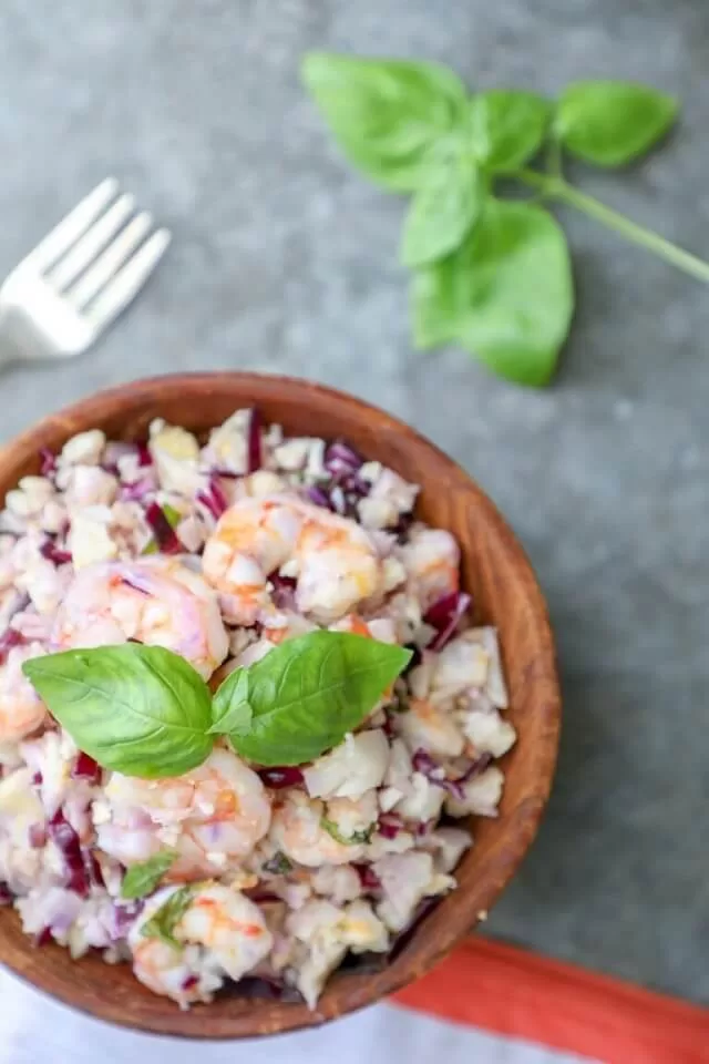 Packed with juicy shrimp, crispy cabbage, delicious cauliflower rice, fresh basil, and a secret ingredient, this salad is bursting with flavor and texture.