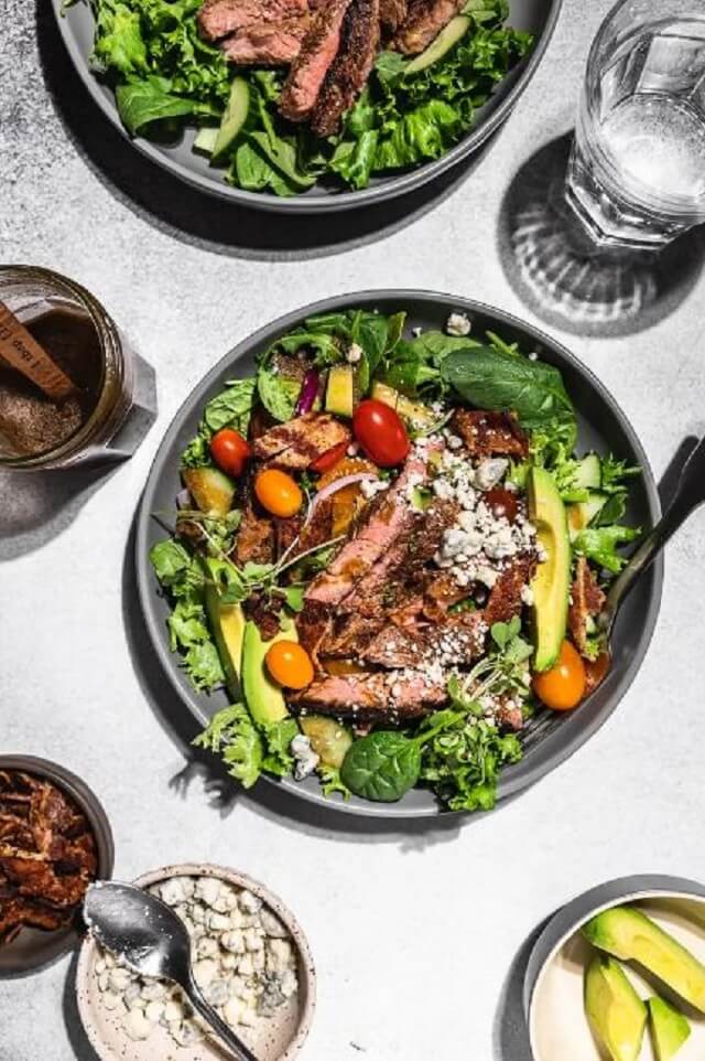 It's the perfect low-carb meal that combines fresh greens, colorful veggies, and tender, juicy ribeye steak, all tossed in a creamy Dijon balsamic dressing and topped with crumbled blue cheese.