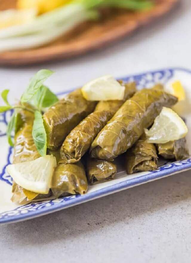 These little bites are made by wrapping grape leaves around a mixture of rice, pine nuts, and fresh herbs.