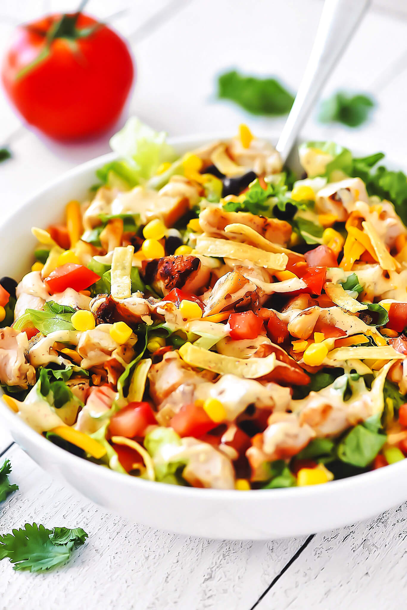 We're talking crisp romaine lettuce, sweet corn, hearty black beans, juicy tomatoes, fresh green onions, and, the star of the show, some killer grilled chicken.