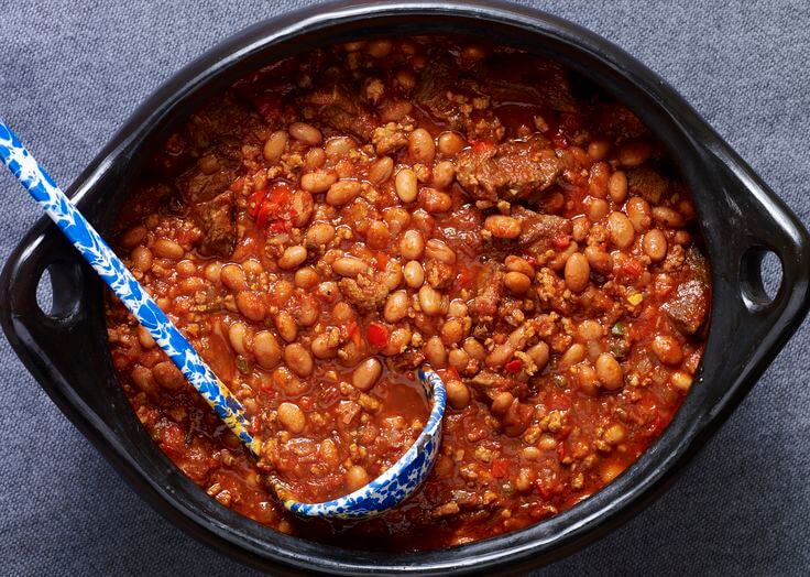 Alright, so regular Texas chili is an awesome mix of chili peppers and meat. But check out this Tex-Mex twist – the one you've likely chowed down on a bunch. It throws in beans and sometimes corn for that extra kick.