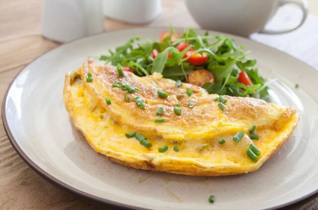 A hearty omelet loaded with cheese, onions, and potatoes.