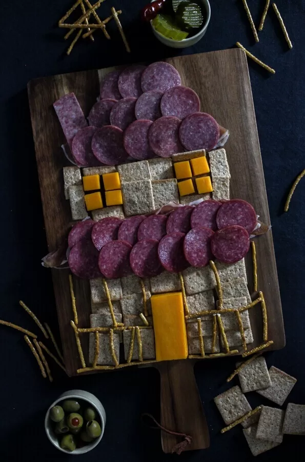 Build a haunted house using crackers, meats, and cheese.