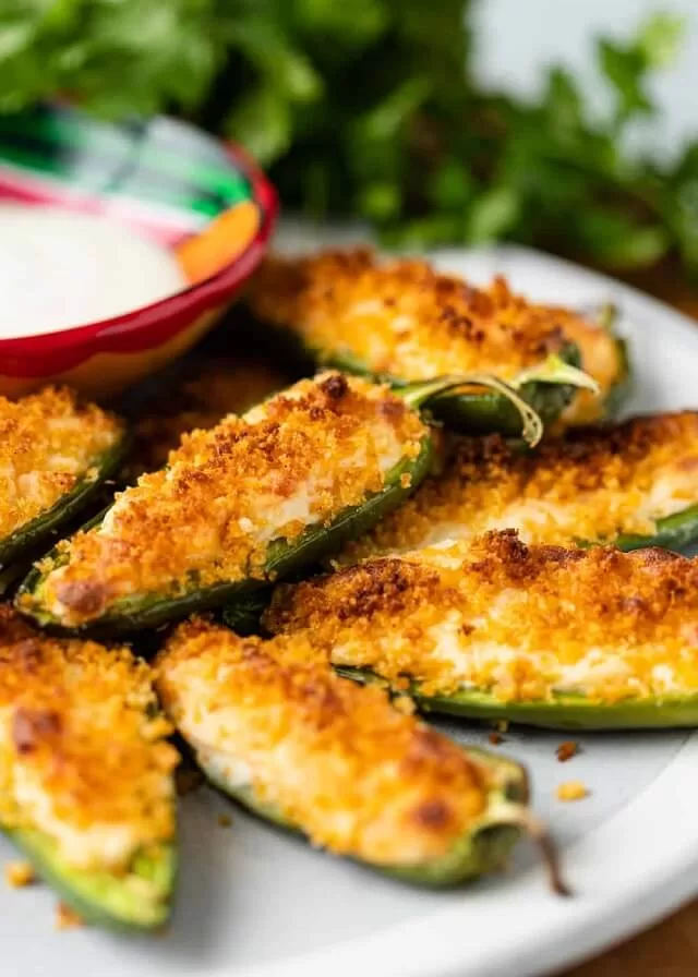 Stuffed jalapeno poppers are spicy, cheesy, and baked until golden. Fresh jalapeños are filled with cream cheese and cheddar for bold flavor. Visit https://sharpaspirant.com