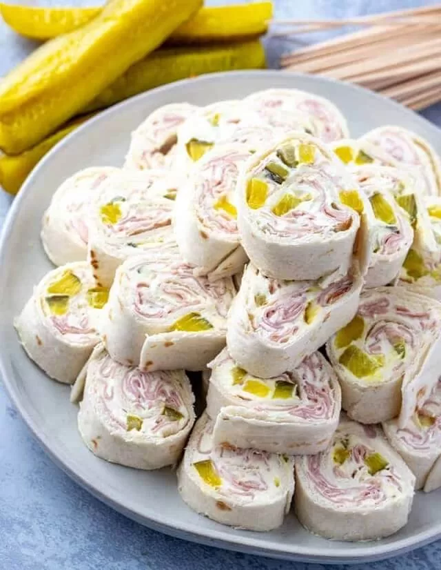 Pickle dip pinwheels are creamy, crunchy, and packed with flavor. They combine cream cheese, ham, and diced pickles in a tortilla wrap. Visit https://sharpaspirant.com