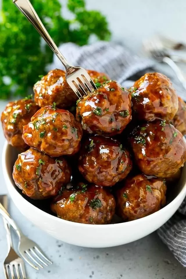 Sweet and sour meatballs are slow-cooked to tender perfection. The sauce is made with only two simple ingredients. Visit https://sharpaspirant.com