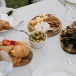 A top shot of a clean minimalist dining table with no-cook appetizers for Spring hosting ideas.