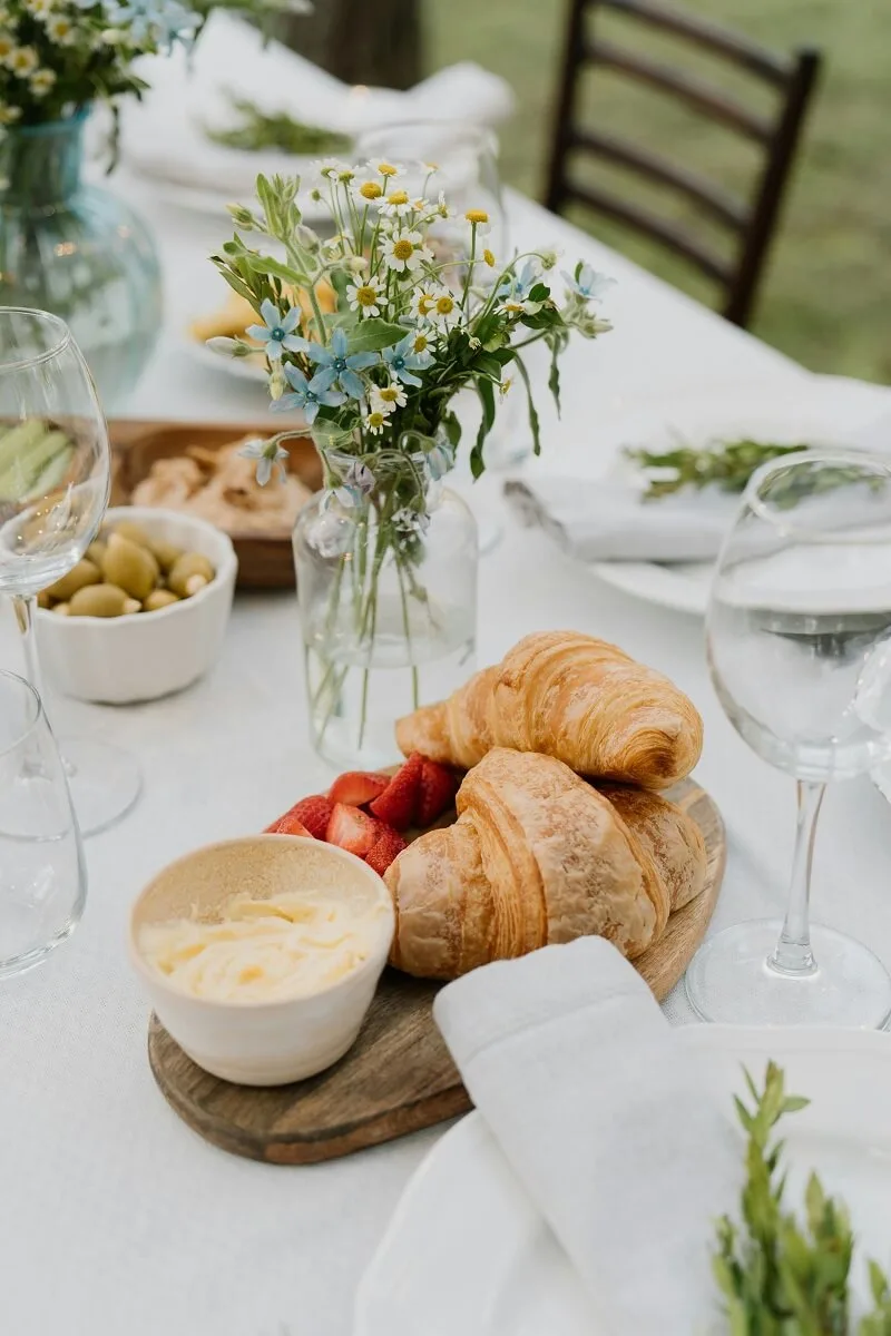 A top shot of a clean minimalist dining table with no-cook appetizers for Spring hosting ideas.