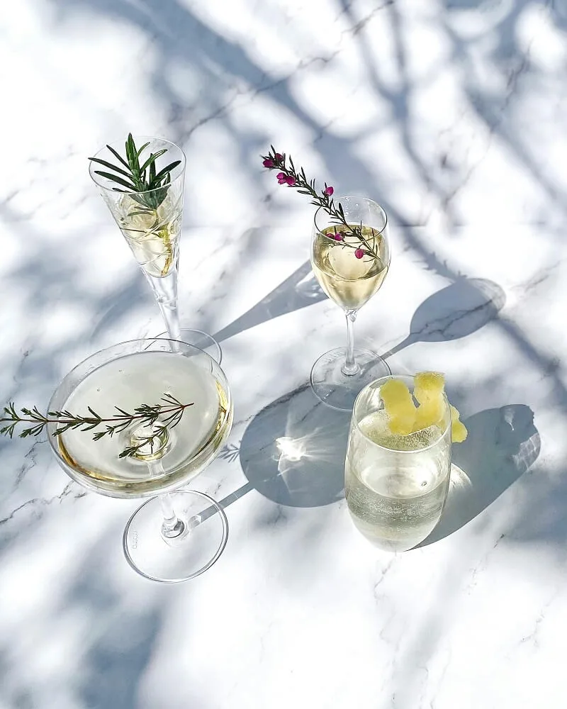 Beautiful clear glasses of drinks on a marble top for an elevated hosting vibe.
