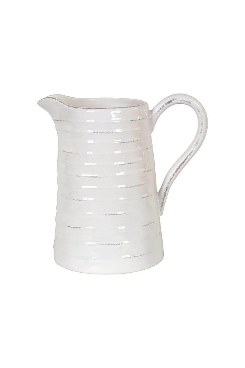 Matte grey ceramic water carafe with a sculptural minimalist silhouette on a sun-drenched table.